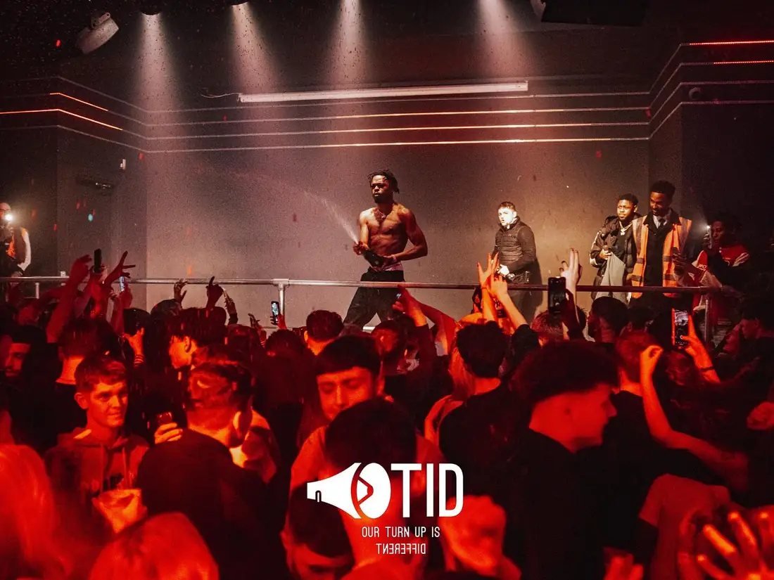 An OTID stage and crowd under red light
